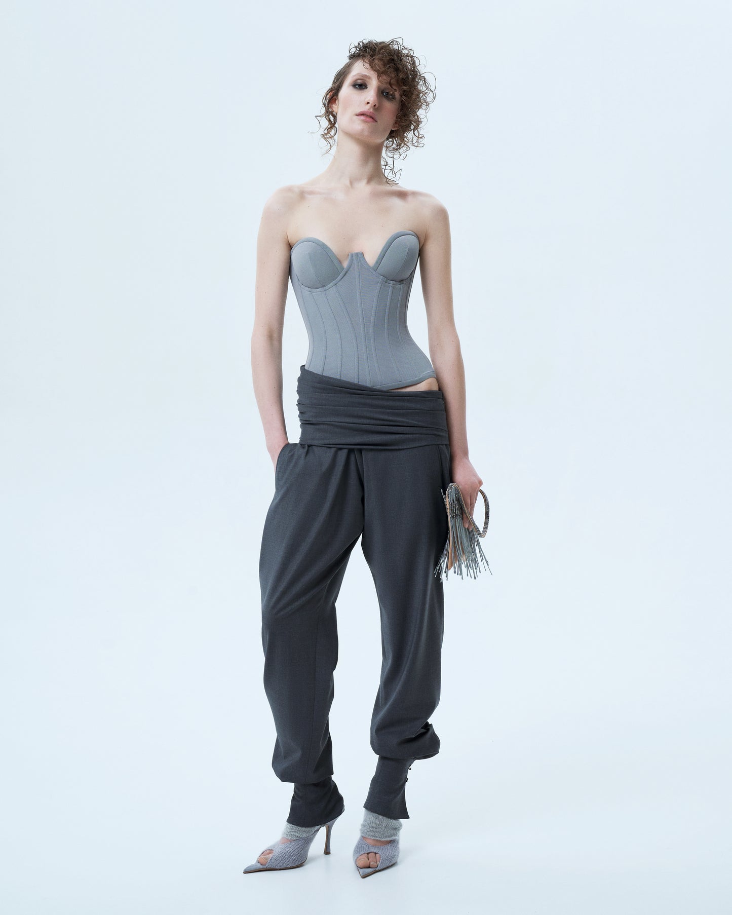 Trousers with asymmetric draped belt